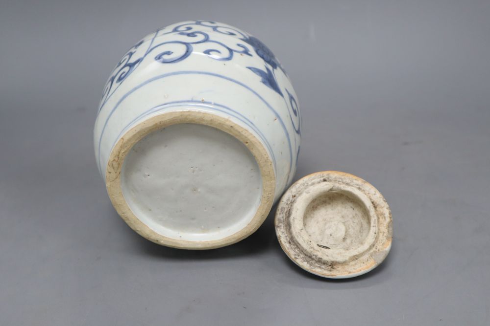 A Chinese Late Ming blue and white lion and lotus jar and cover, overall height 17.5cm, restored rim